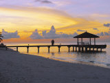 Couple on Jetty Looking at Sunset, Maldives, Indian Ocean