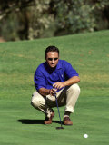 Male Golfer Lining Up a Putt