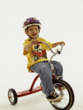 4 Year Old Boy Posing on His Tricycle, New York, New York, USA