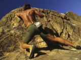 Man Rock Climbing Without Equipment