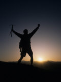 Mountain Climber Rejoices at the Summit at Sunrise