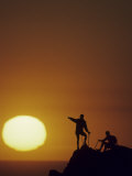 Two Mountain Climbers at Sunset