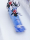 Blurred Action of 4 Man Bobsled Team Pushing Off at the Start