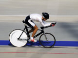 Action of Female Cyclist Competing on the Velodrome