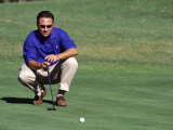 Male Golfer Lining Up a Putt