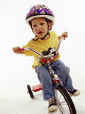 4 Year Old Boy Posing on His Tricycle, New York, New York, USA