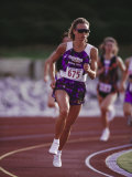 Buy Female Runner Competing in a Track Race at AllPosters.com