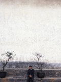 Buy Man sits at the base of West Pagoda, Kunming, Yunnan Province, China at AllPosters.com