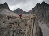 Buy Mountaineer Runs Atop a Cliff in the Cirque of the Unclimbables at AllPosters.com