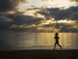 Buy Silhouetted Woman Jogging on a Beach at Twilight at AllPosters.com