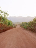 Long Dirt Road Leading into the Nearby Mountains in South East Asia
