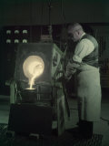 Man Pours New Metal Alloy from Furnace to Mold for Telephone Magnets