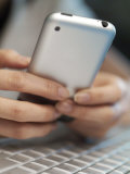 Buy Female Hands Hold a Cell Phone over a Laptop at AllPosters.com