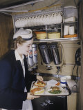 Buy Flight Attendant Sets Up a Passengers Meal on United Airlines at AllPosters.com