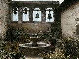 Buy Woman Stands Next to a Fountain in Mission of San Juan Capistrano at AllPosters.com