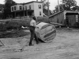 Buy Man Rolls a Barrel of Tobacco Down to the Wharf for Shipment at AllPosters.com