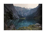 This Avalanche Formed Lake Sits Between Mountains and a Wild Crag