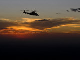 Helicopter Silhouetted Against a Dramatic Sky at Sunset