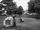 Man Sits on a Bench by a Monument to John O'Neill at Havre De Grace