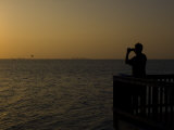 Man Takes a Photo of the Sunset