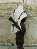 Israeli Soldier with Rifle Praying at the Wailing Wall