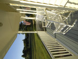 Buy Two Rocking Chairs on a Sunlit Porch with an American Flag at AllPosters.com