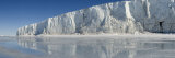 Buy Three Skiers Pull Sleds on Sea Ice Near a Floating Glacier Tongue at AllPosters.com