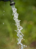 Stop Motion Image of Water Pouring from an Outdoor Well Spicket