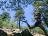 Woman Trail Running in Mountains