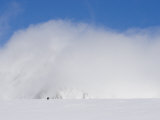 Buy Two Distant Climbers Ascend a Glacier Toward a Cloud-Covered Peak at AllPosters.com