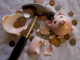 Hammer Lies Amidst the Ruins of a Piggy Bank and its Coins
