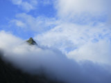 Peak of a Jagged Volcano Emerges from Cloud Cover