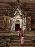 Young Burmese Girls Emerge from a Temple Carved in Rock