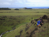 Hiker Climbing Above a Stream on Easter Island