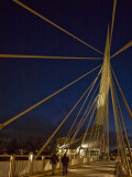 Pedestrians Cross the Modern Bridge at Night