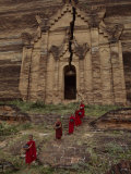 Young Monks Emerge from a Temple Carved in Rock