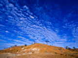 Clouds Roll over a Volcanic Red Hill Rising from a Desert Plain
