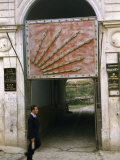 Buy Man Walks Past an Archway Containing a Symbol of Republican Party at AllPosters.com
