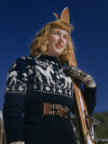 Buy Young Woman in Wool Ski Sweater and Mittens Holds Her Skis at AllPosters.com