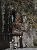 Buy Two People Stand in Front of a Replica of the Grotto of Lourdes at AllPosters.com