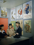 Buy Flight Attendants Stand and Talk Beneath Airline Advertising Posters at AllPosters.com