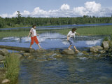 Buy Barefoot Women Cross Rocks in Narrow Mississippi River at its Source at AllPosters.com