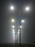 Winter Fog Engulfs Freeway Lighting on Cross-Town City Bridge