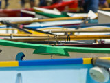Colorful Surf Boats Line a Sunny Beach During a Racing Carnival
