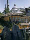 Buy Green Mosque's Domes Overlook Tiled Roofs and Tilting Tombstones at AllPosters.com