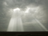 Sun Rays Shine Through a Small Opening in the Clouds of a Dying Storm