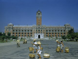 Buy Barefoot Men Carry Baskets Past Government Building at AllPosters.com