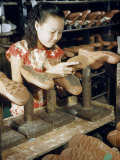 Worker Attaches Rubber Soles to Canvas Shoes in a Factory