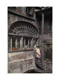Two Women Stand by a Fan Window That Streams Sunlight into a Studio