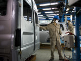 Buy Workers Move Vehicles Along the Assembly Line at Ford Vietnam at AllPosters.com
